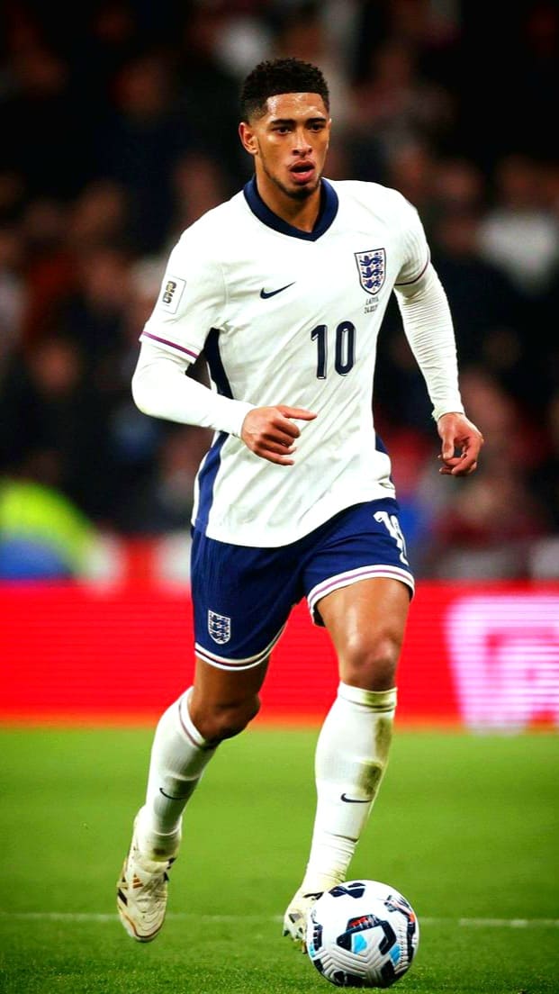 A male soccer player wearing an England national team uniform with the number 10 dribbles a ball on a field during an IPTV French broadcast of the match.