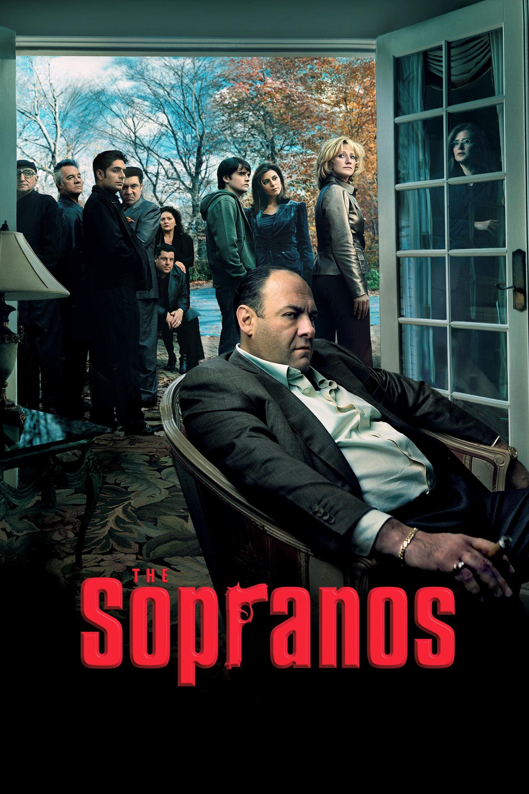 A man sits in a chair indoors, looking serious, while several people stand outside near open patio doors. The iconic Sopranos logo is displayed in red at the bottom, capturing the classic vibe—now streaming through IPTV FRENCH for fans everywhere.